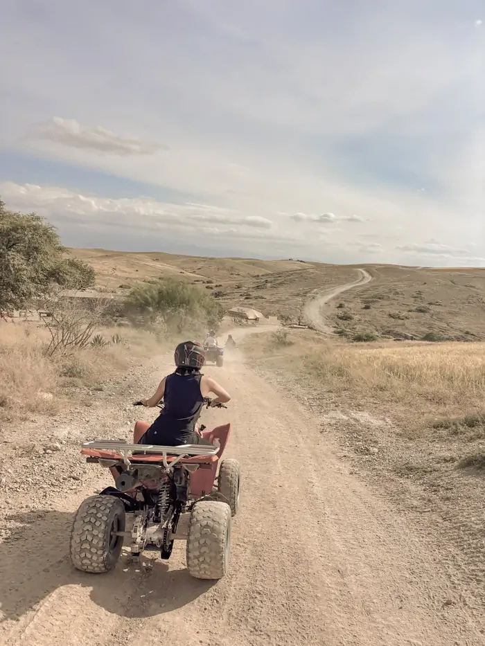 Riding a quad bike across the open plains