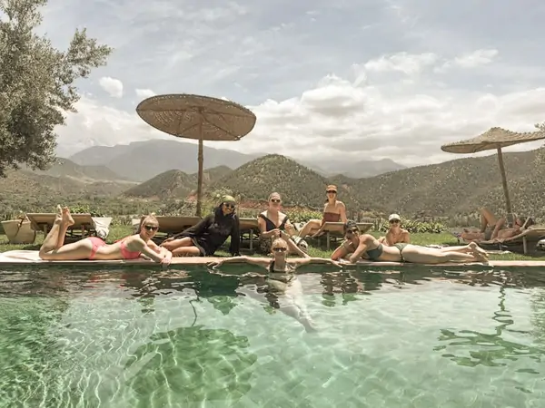 Floating in the pool with the mountains behind