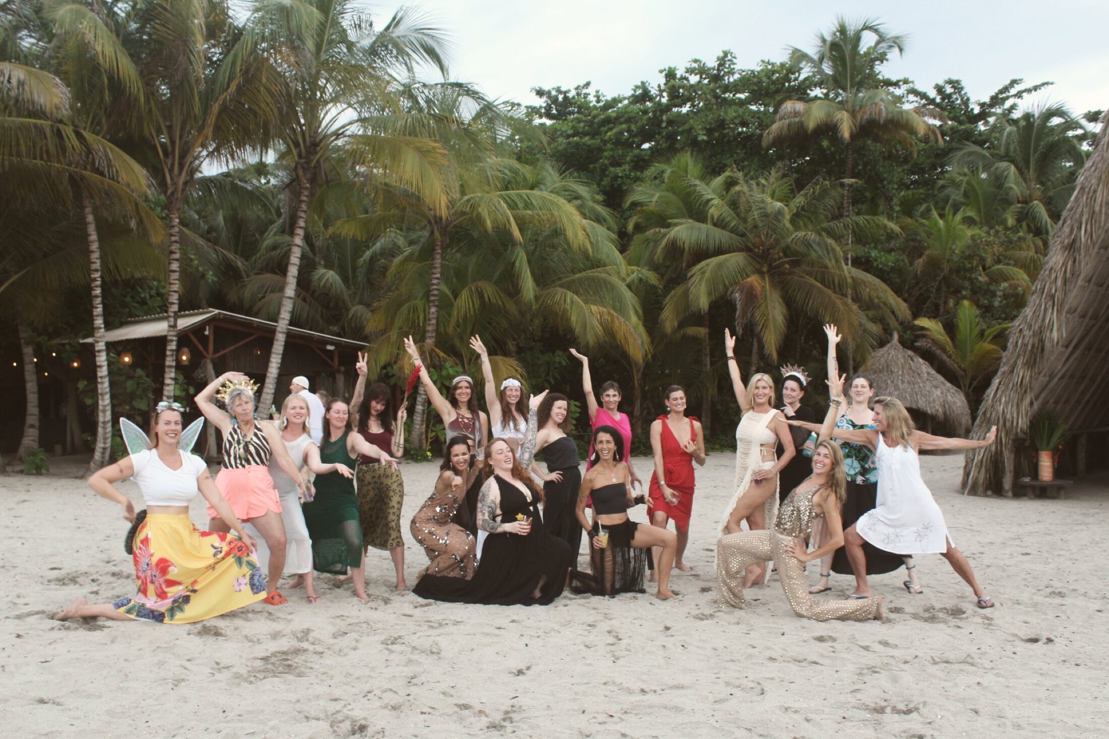 The group celebrating on the beach at dusk