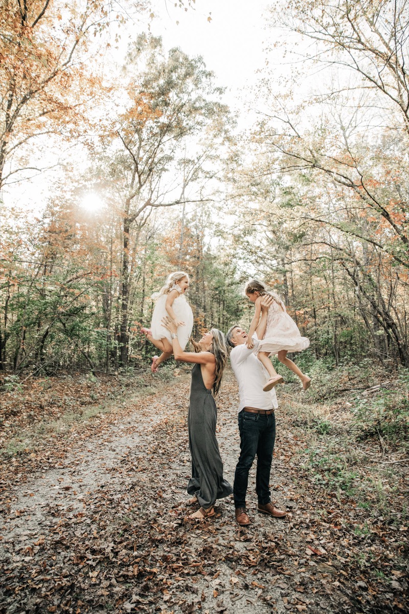 Brisa and her family lifting the girls on a trail