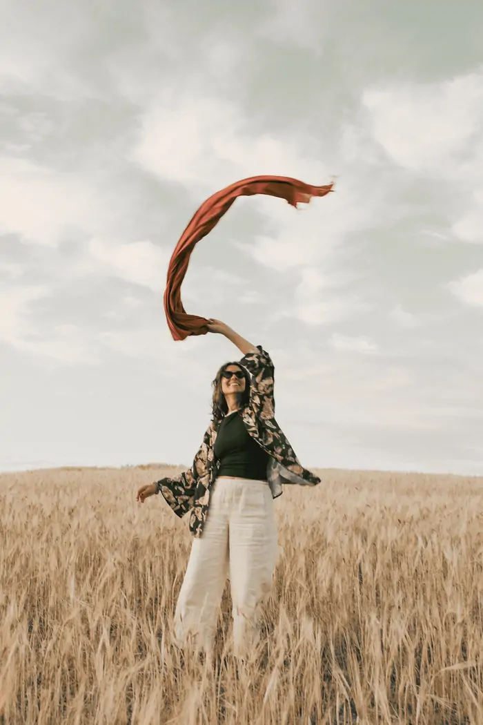 Throwing a scarf to the wind over the wheat field