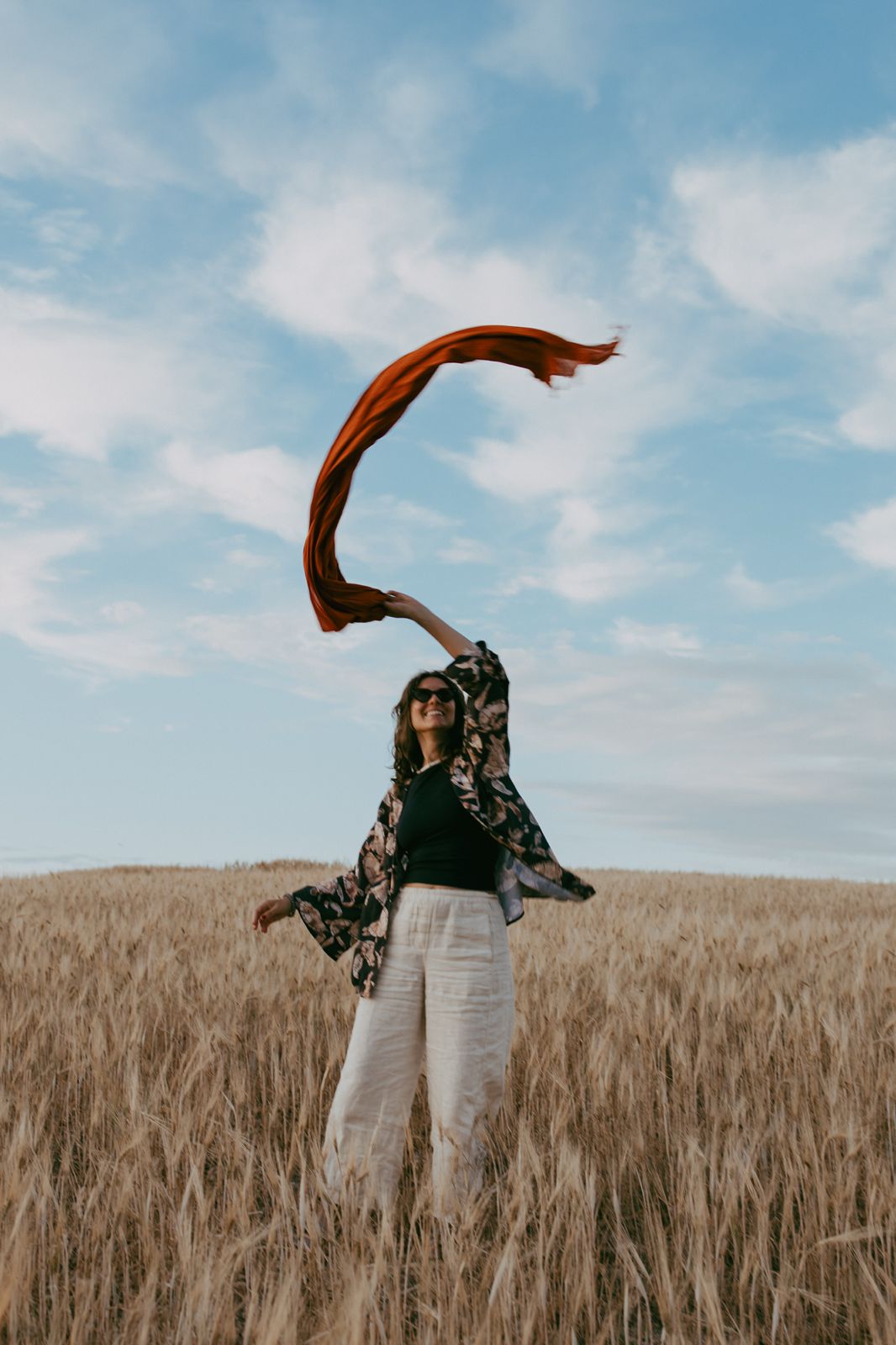Throwing a scarf to the wind over the wheat field